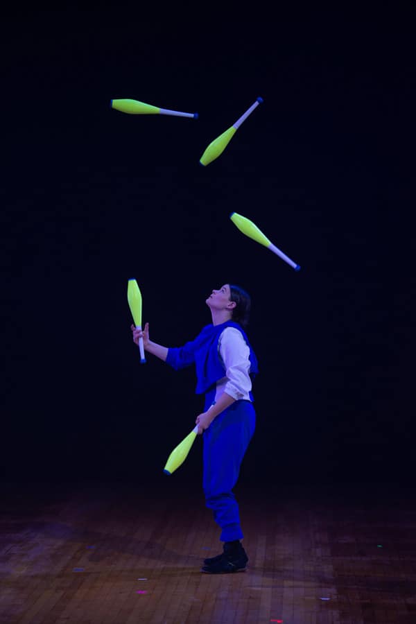 Cirque-Orenda-Jugglers person juggles glow in the dark clubs during cirque orenda performance